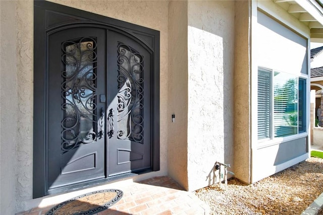 doorway to property with stucco siding