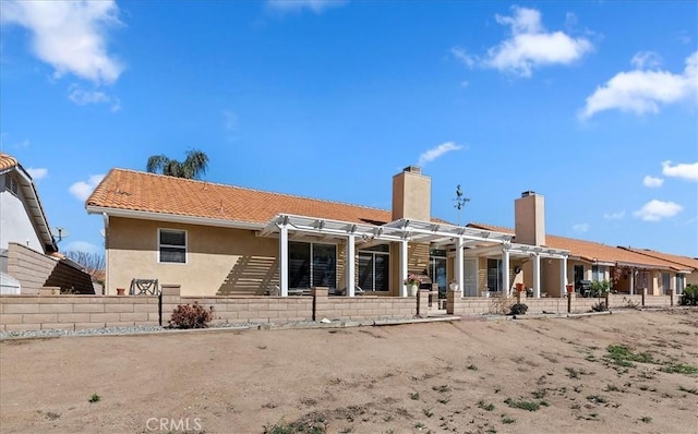 back of house featuring stucco siding, a tiled roof, and a pergola