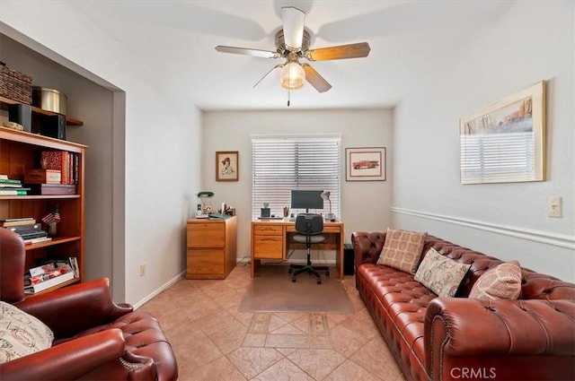 office featuring a ceiling fan and baseboards