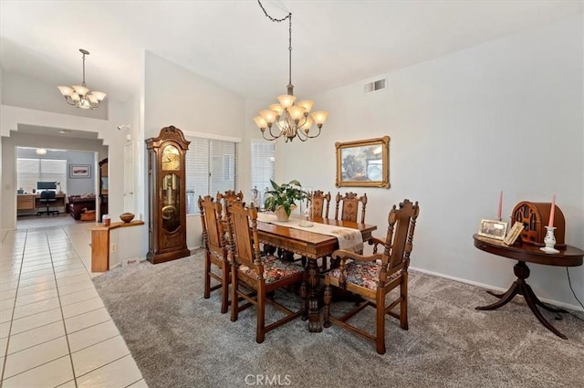 carpeted dining room featuring a chandelier, visible vents, plenty of natural light, and tile patterned floors