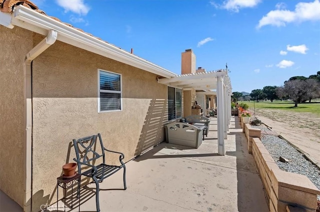 view of patio featuring grilling area and a pergola