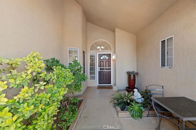 view of exterior entry featuring stucco siding