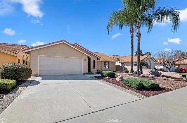 single story home with an attached garage, a tile roof, driveway, a residential view, and stucco siding