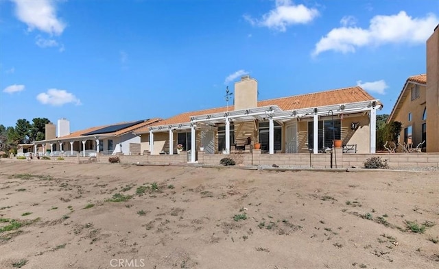 rear view of property with a chimney