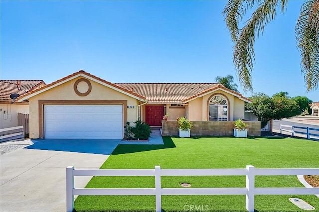 view of front facade with stucco siding, concrete driveway, an attached garage, a front yard, and fence