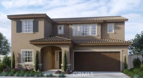 view of front of home with a garage, concrete driveway, and stucco siding