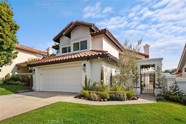 mediterranean / spanish house with driveway, a front lawn, a tile roof, and a gate