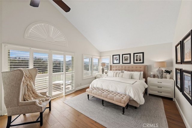 bedroom featuring access to outside, high vaulted ceiling, wood finished floors, and baseboards