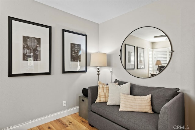 living room with baseboards and wood finished floors