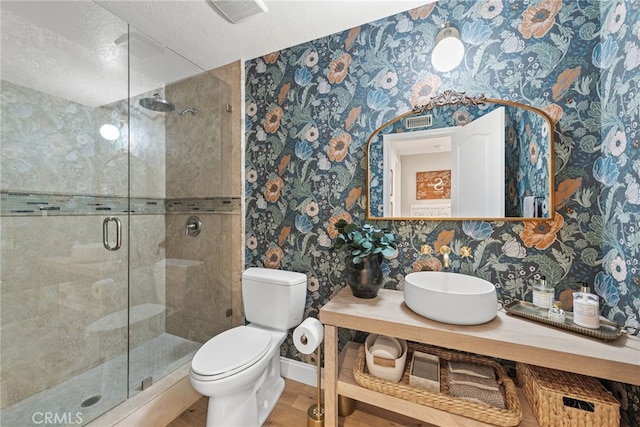 full bath featuring wallpapered walls, visible vents, baseboards, toilet, and a shower stall