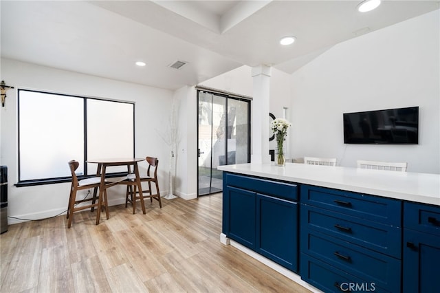 kitchen featuring light wood finished floors, recessed lighting, light countertops, visible vents, and blue cabinets