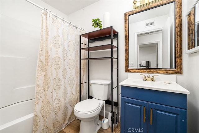 full bath featuring shower / tub combo, visible vents, toilet, wood finished floors, and vanity