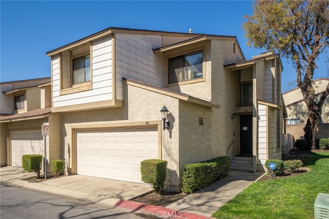 townhome / multi-family property featuring an attached garage and stucco siding