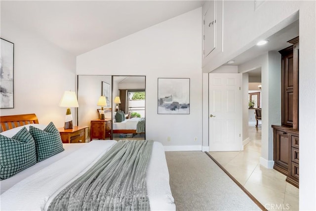 bedroom with high vaulted ceiling, light tile patterned flooring, and baseboards