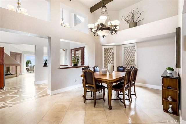 dining space featuring light tile patterned flooring, a notable chandelier, and baseboards