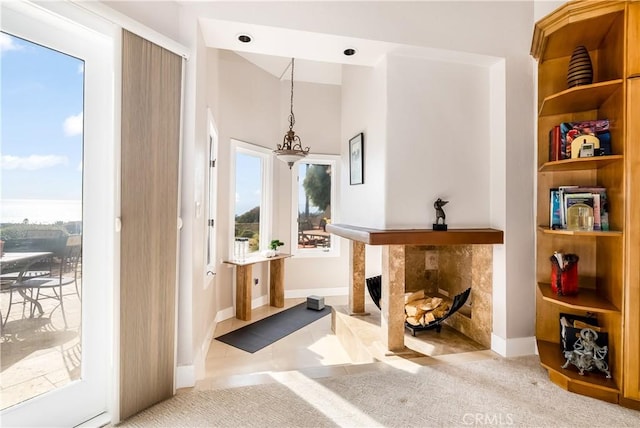 interior space featuring carpet, baseboards, and a tile fireplace