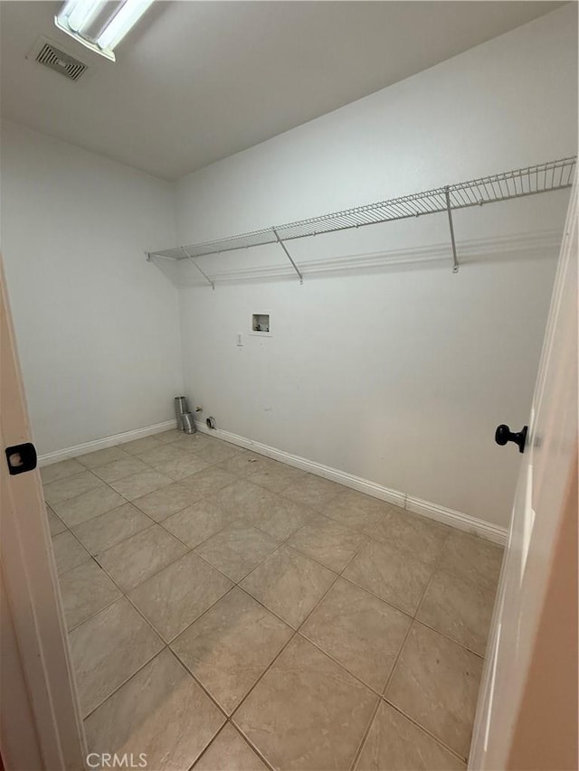 laundry area with laundry area, baseboards, hookup for a gas dryer, and washer hookup