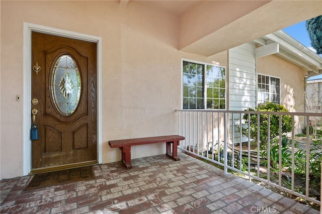 property entrance with stucco siding