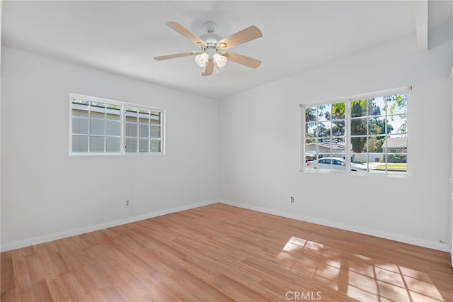 empty room featuring ceiling fan, wood finished floors, and baseboards