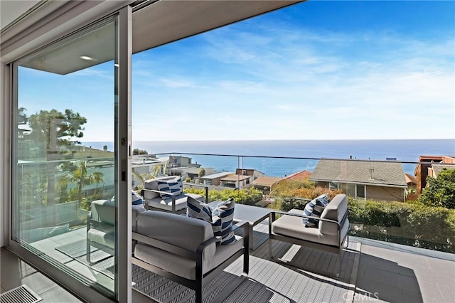 balcony featuring a water view