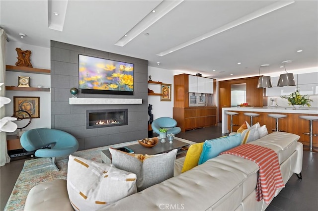 living room featuring a large fireplace and recessed lighting