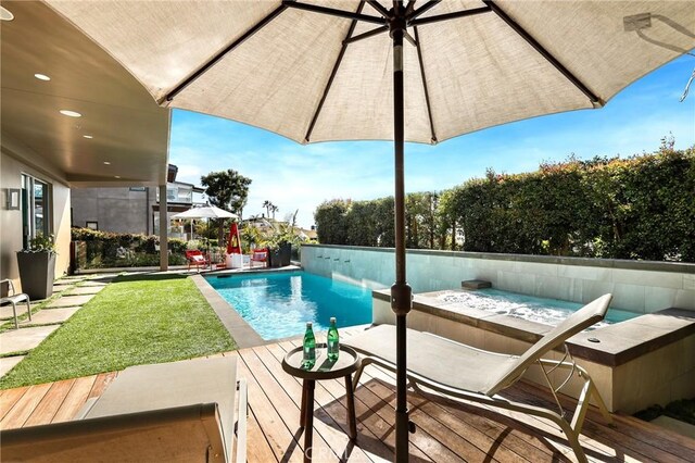 outdoor pool featuring a fenced backyard and a deck