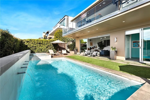 view of pool with fence, outdoor lounge area, and an in ground hot tub