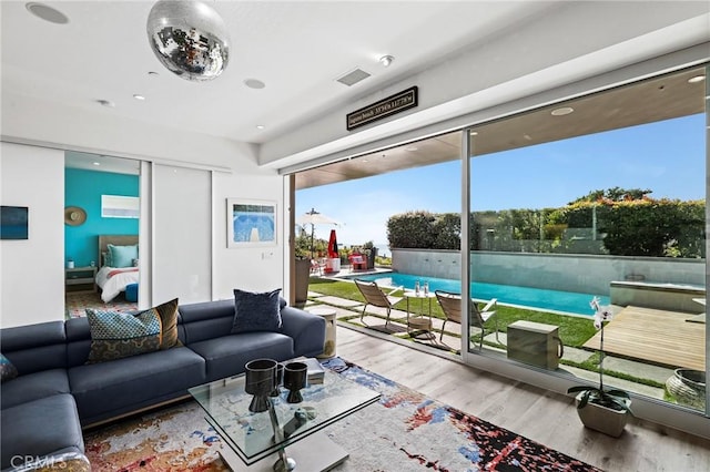 living room featuring visible vents and wood finished floors