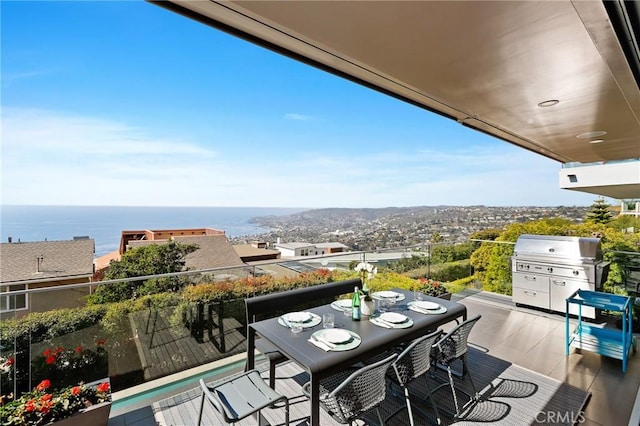 balcony with a water view and a grill