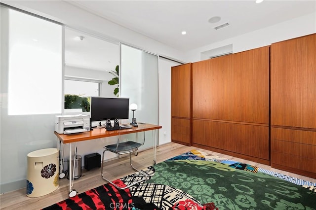 office space with light wood-style flooring, visible vents, and recessed lighting