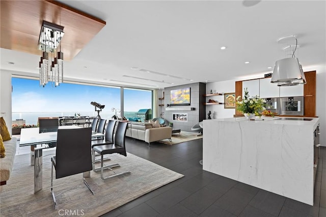 dining room with a notable chandelier, recessed lighting, and floor to ceiling windows