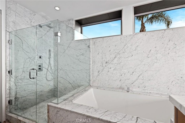 bathroom with vanity, a marble finish shower, a bath, and recessed lighting