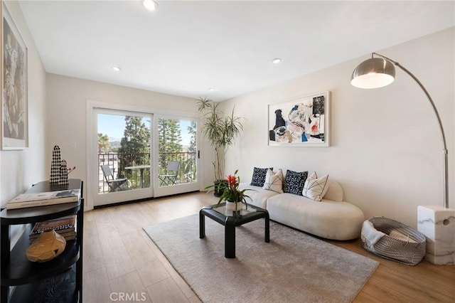 living area featuring recessed lighting and light wood-style flooring