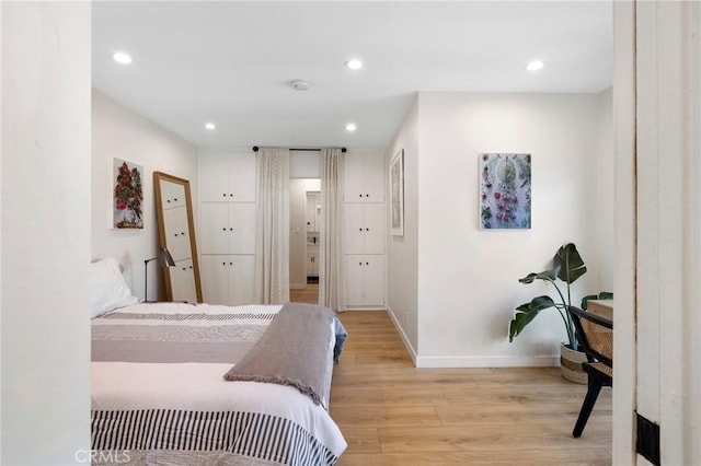 bedroom with light wood-style floors, baseboards, and recessed lighting