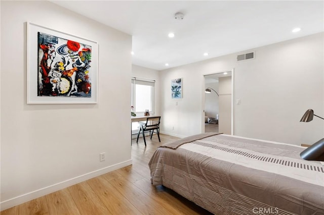 bedroom featuring recessed lighting, light wood-type flooring, visible vents, and baseboards