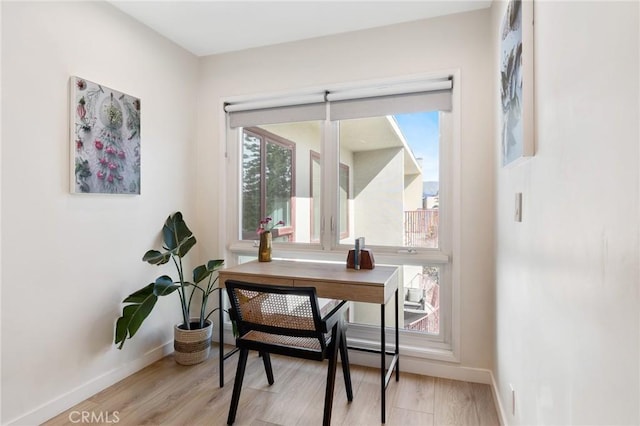 office area with light wood-type flooring and baseboards