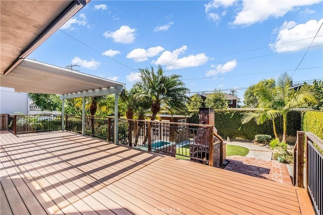 wooden deck featuring fence and a patio area