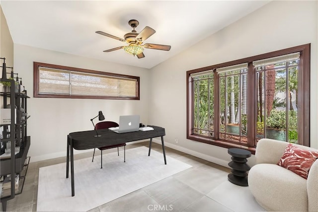 office featuring baseboards, a ceiling fan, and vaulted ceiling