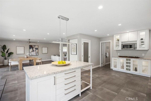 26925 Calle Dolores, Dana Point, CA 92624 - kitchen with stainless steel microwave, recessed lighting, a ceiling fan, white cabinets, and a kitchen island