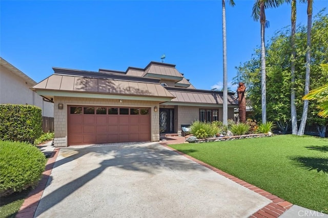 26925 Calle Dolores, Dana Point, CA 92624 - view of front of house with a standing seam roof, a metal roof, a front lawn, and an attached garage