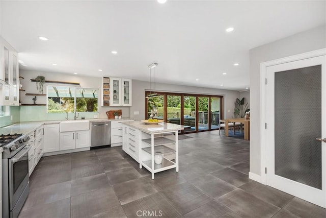 26925 Calle Dolores, Dana Point, CA 92624 - kitchen with open shelves, appliances with stainless steel finishes, a sink, white cabinetry, and recessed lighting