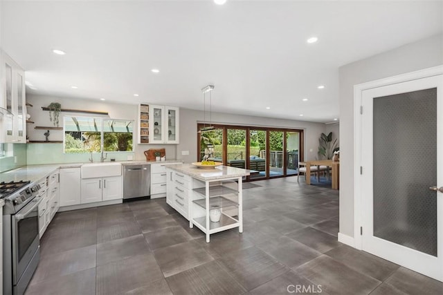 26925 Calle Dolores, Dana Point, CA 92624 - kitchen with open shelves, stainless steel appliances, white cabinets, recessed lighting, and glass insert cabinets