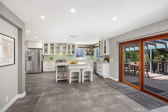 26925 Calle Dolores, Dana Point, CA 92624 - kitchen with stainless steel appliances, wall chimney range hood, a center island, a kitchen breakfast bar, and recessed lighting