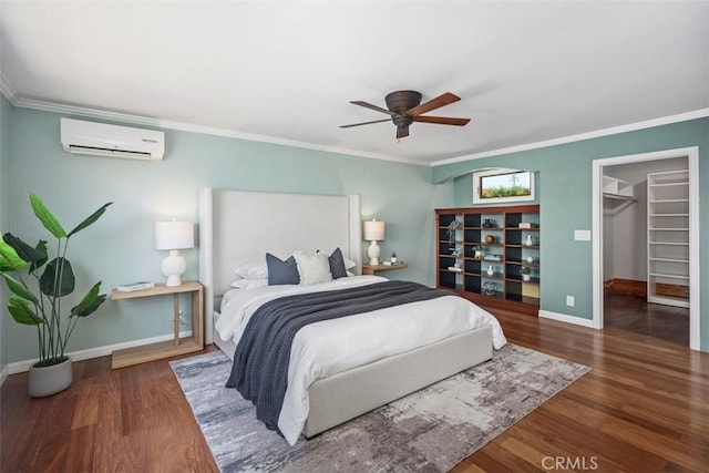 26925 Calle Dolores, Dana Point, CA 92624 - bedroom featuring an AC wall unit, wood finished floors, crown molding, baseboards, and a walk in closet