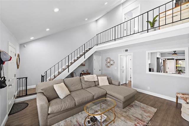 living area with recessed lighting, a high ceiling, visible vents, baseboards, and dark wood-style floors