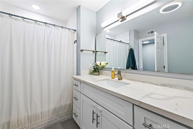 bathroom featuring recessed lighting, visible vents, and vanity