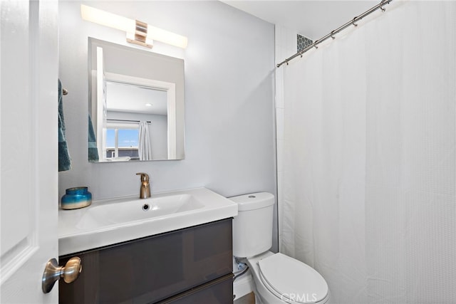 bathroom featuring toilet and vanity