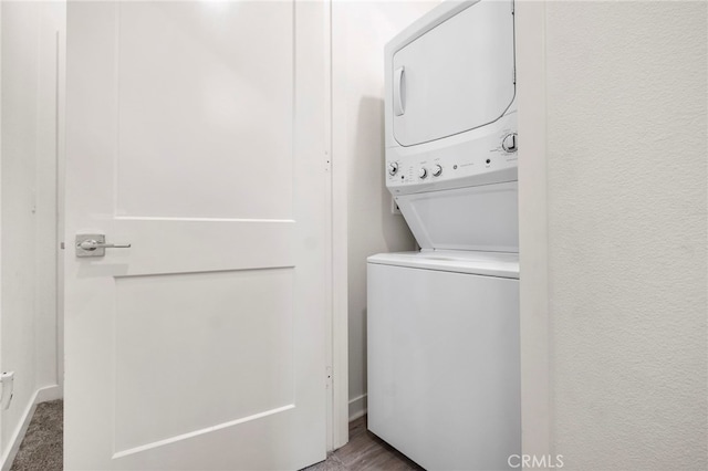 laundry area featuring stacked washer and clothes dryer