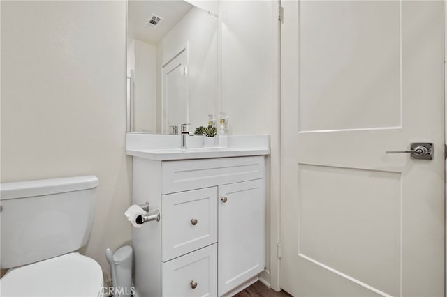 bathroom featuring toilet and vanity