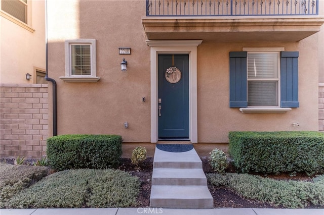 property entrance with stucco siding